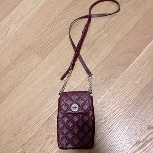 Brand new Kate Spade maroon crossbody/shoulder clutch w/gold accents.